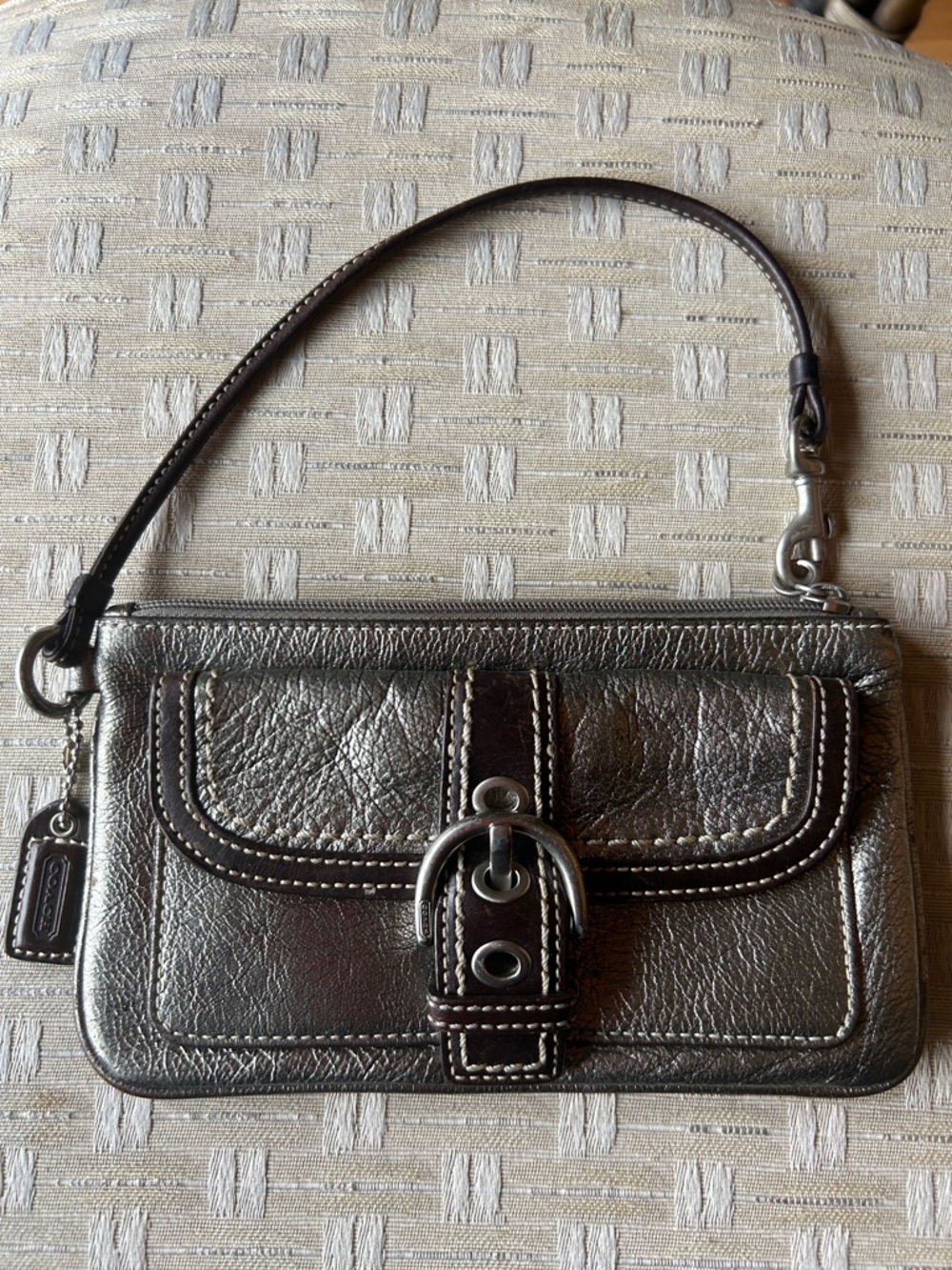 Metallic Pewter Coach Wristlet with outside pocket.